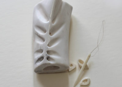 Mending I, 2017  Cattle bone, human bone needle, braided human hair, 6 x 3 x 2 in.